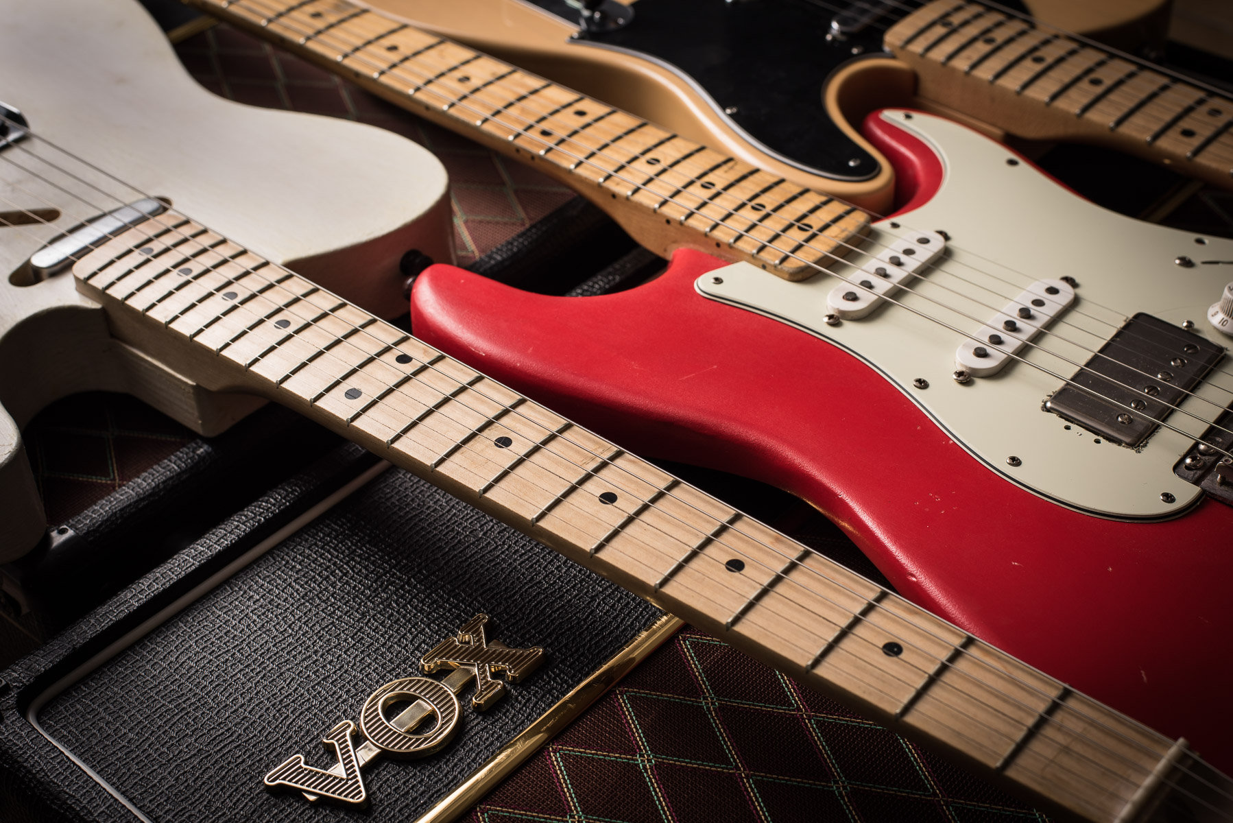 Cover image of a red fender stratocaster and a yellow and white fender telecaster, along with a vox ac30 and ac15 amplifier used as the cover for the "Things to know before your first guitar lesson" blog.